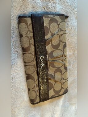 vintage Coach Signature canvas trifold wallet featuring brown monogram fabric